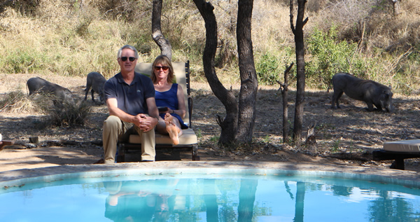 john and joni with warthogs in the background