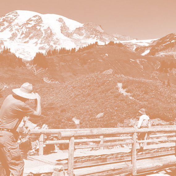 Guy taking photo of Rainier from trail